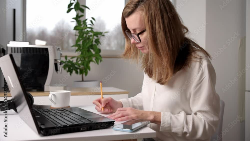 Remote work. Woman works on laptop in home workplace. Distance education and e learning concept Remote work. Woman works on laptop in home workplace. Distance education and e learning concept
