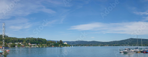 Boating and sailing on the clear waters of alpine Lake Worthersee  famous tourist attraction for many water activity in Klagenfurt  Carinthia  Austria