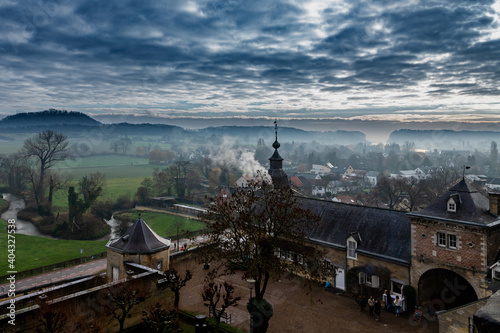 Maastricht, Netherlands 01-10-2021 View from the Cannerberg in Maastricht over Chateau Neercanne and the Jeker Valley covered in fog under a dramatic sky photo