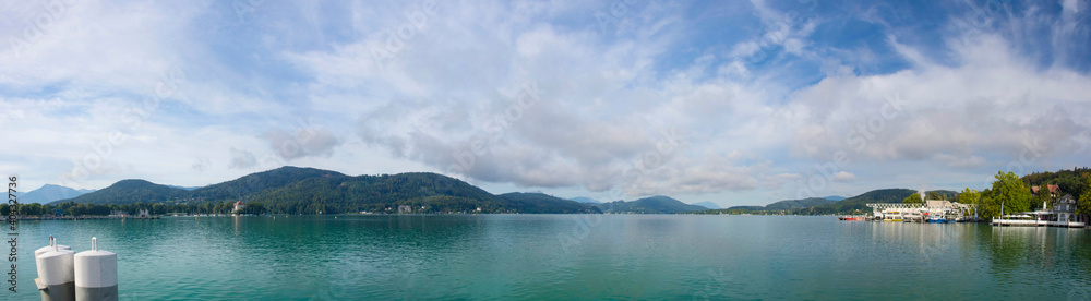 View of the alpine Lake Worthersee, famous tourist attraction for swimming, boating, sunbathing and walking, in Klagenfurt, Carinthia region, Austria