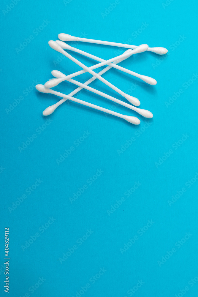 Sticks for cleaning ears on a blue background. Sticks for cleaning ears on a blue background.