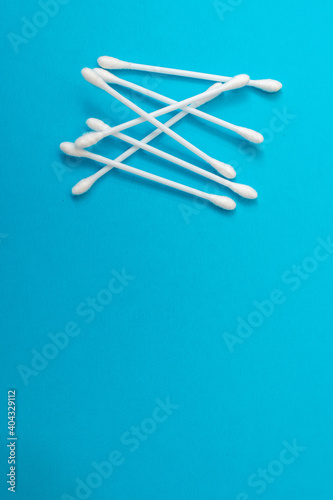 Sticks for cleaning ears on a blue background.