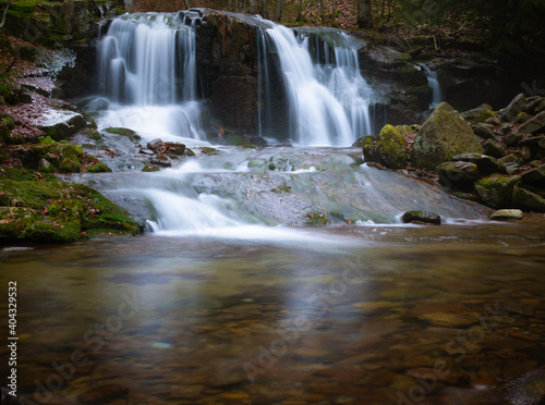 Wild brook with stones and waterfall in Jeseniky mountains, Eastern Europe, Moravia. Clean fresh cold watter, water stream. Long exposure image. .