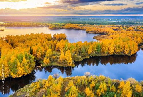  Colorful autumn landscape. Forest lake with autumn forest. Western Siberia