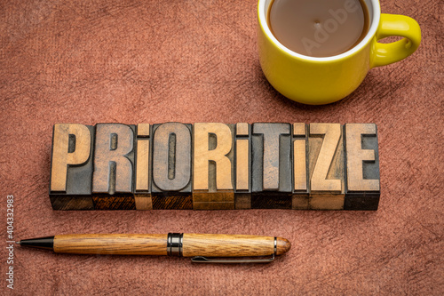 prioritize - motivational word abstract in vintage letterpress wood type with a cup of coffee, business or lifestyle concept photo