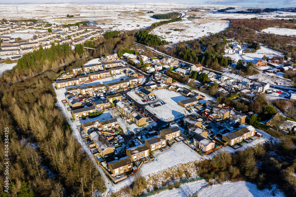 Aerial view of snow covered houses and streets in a small town