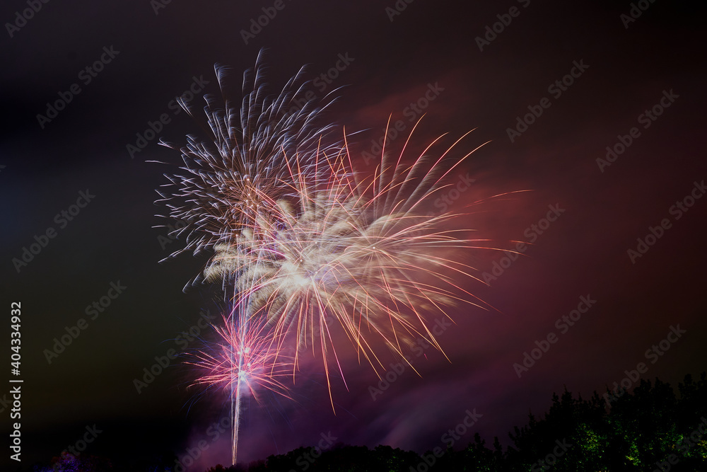 Beautiful multicolored fireworks in the night sky as a background.