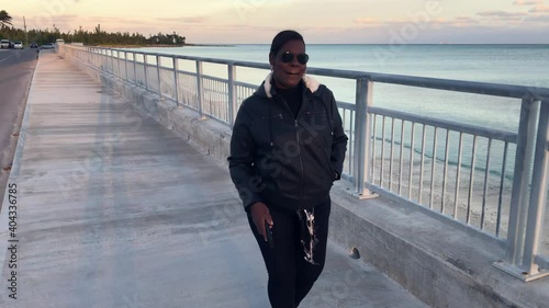 Old Bahama Mama OBM at Sea wall in Black Outfit. Freeport, Bahamas   photo