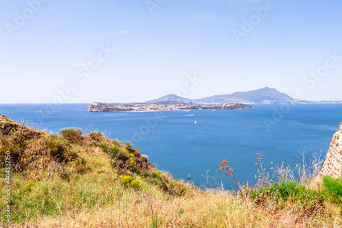 a postcard of the island of Procida e Ischia on a beautiful sunny day with calm sea