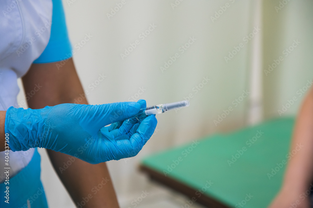 The doctor injects the flu, pneumonia, or COVID-19 vaccine into the patient's shoulder The doctor injects the flu, pneumonia, or COVID-19 vaccine into the patient's shoulder
