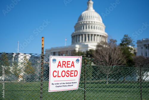 Area Closed sigh on Fence on blurred United States Capitol Building background.
