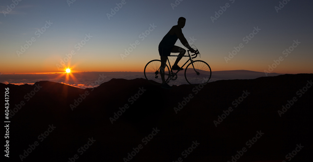 Obraz premium The silhouette of the cyclist on bike at sunset.A man ride on bike on the mountains. Sport and active life concept sunset time. A man riding a bicycle in a nature.