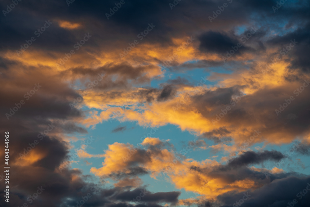 Dramatic clouds rising of sun floating in blue sky to change summer weather. Soft focus, motion blur amazing meteorology cloudscape background.