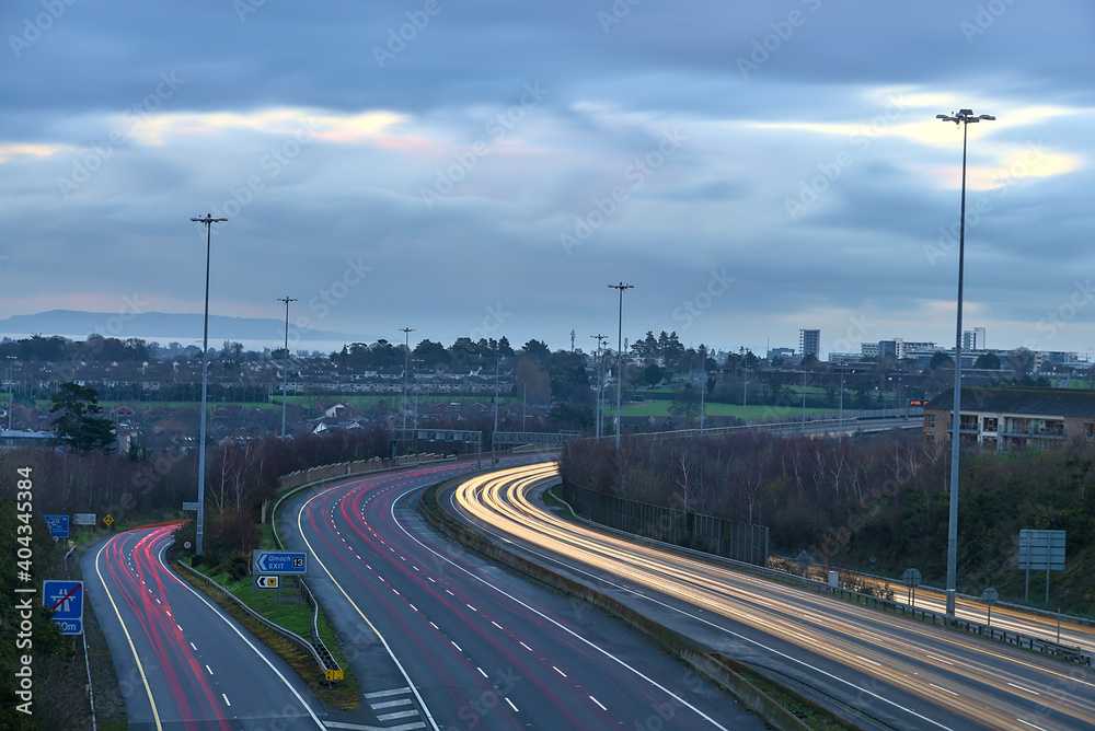 Beautiful very long exposure evening view of light trails of vehicles on motorway M50 Dublin, Ireland. Transportation during Level 5 in Dublin