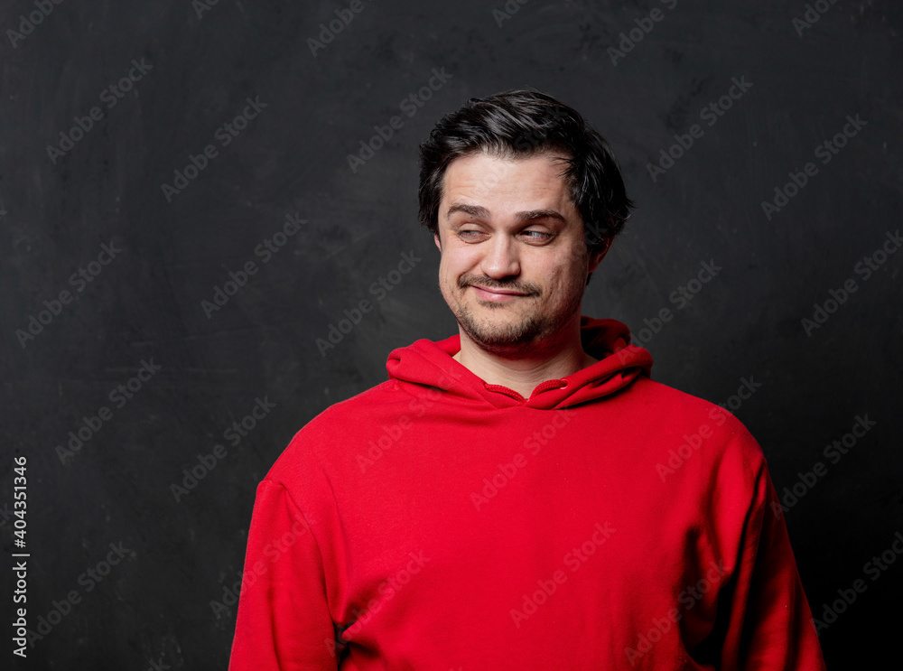 White fool guy in red sweatshirt on dark background
