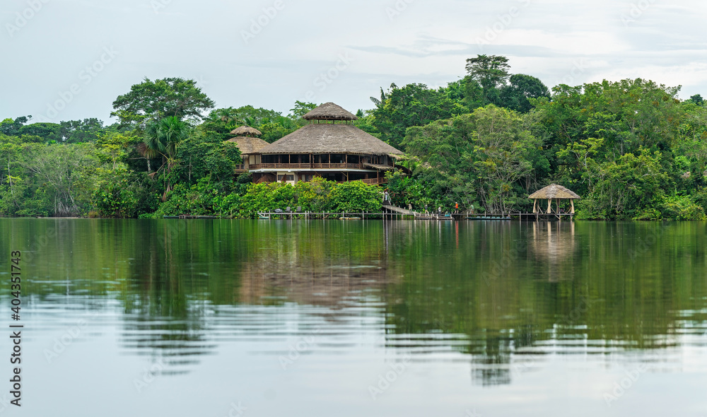 Reflection of an Amazon rainforest lodge. The Amazon river tributaries comprise the countries of Suriname, Guyana, French Guyana, Venezuela, Colombia, Ecuador, Peru, Bolivia and Brazil. Reflection of an Amazon rainforest lodge. The Amazon river tributaries comprise the countries of Suriname, Guyana, French Guyana, Venezuela, Colombia, Ecuador, Peru, Bolivia and Brazil.