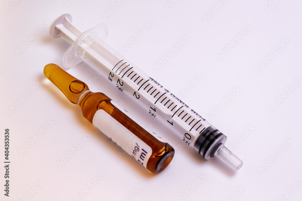 Syringe and a medication vial on a white background Syringe and a medication vial on a white background