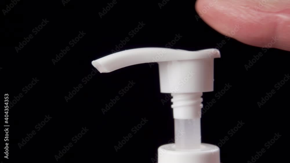 Close-up of a male finger squeezing out hand sanitizer to prevent the spread of virus and infection. Dispenser. Macro shot Close-up of a male finger squeezing out hand sanitizer to prevent the spread of virus and infection. Dispenser. Macro shot