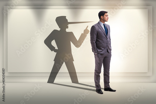 Concept of businessman liar with his shadow photo