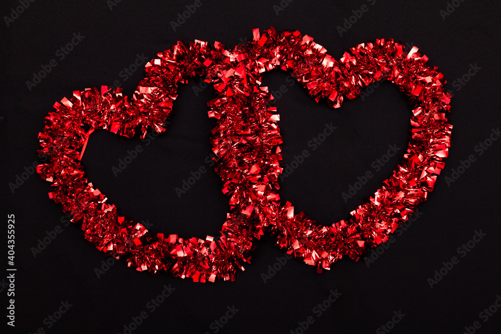 Two red hearts on a black background