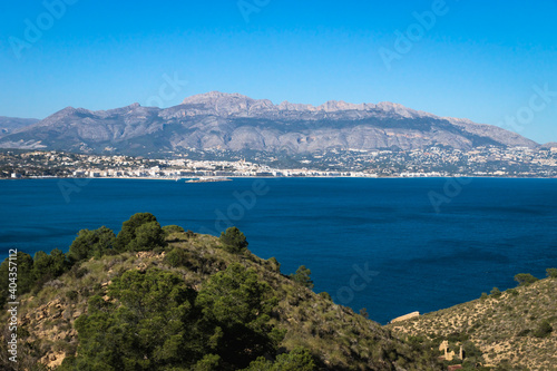 Natural park 'Serry Gelada' with view to Altea under mountainrange and ruin of ocher mine along the coast of Albir, Spain