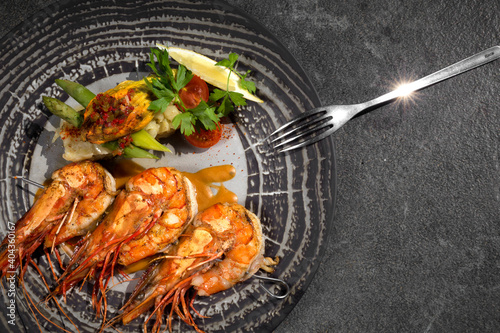 Top view of plate with shrimp and salad and fork