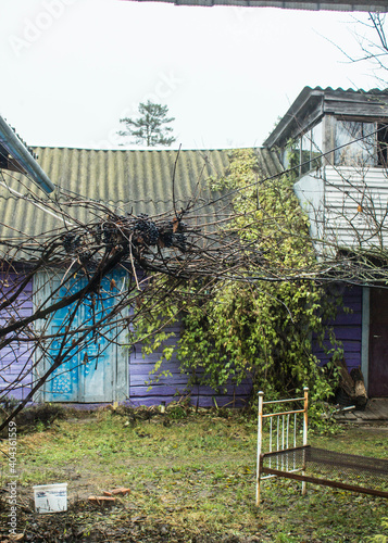 A very old house. Abandoned house, old courtyard. Vintage. Windows of an old house. Old yard with chickens. Background.