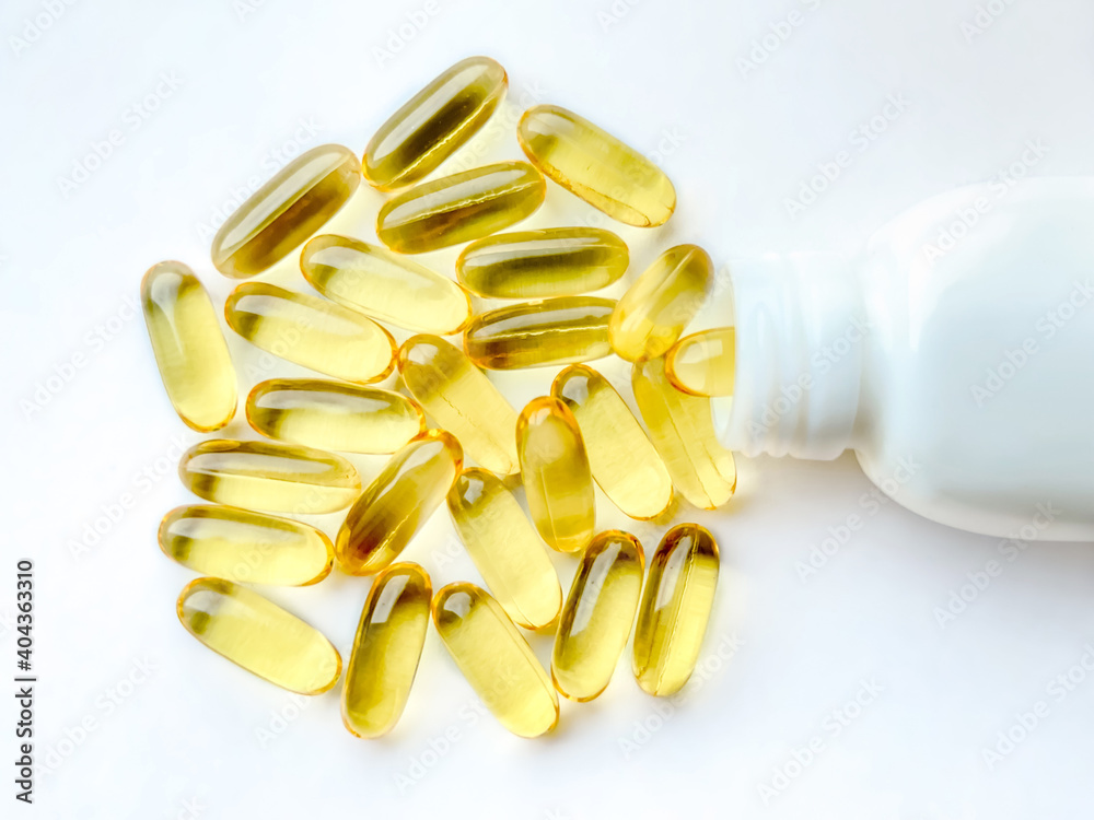 Omega-3 capsules with the bottle on white background. Polyunsaturated fatty acids. The concept of a healthy lifestyle.