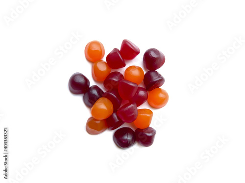 Group of red, orange and purple multivitamin gummies isolated on white background. Healthy lifestyle concept.. photo