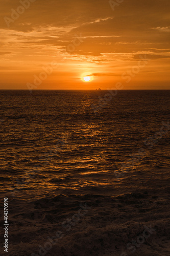 Beautiful sunset in Lima Peru, bright sky and underexposed beach, golden hour, orange sky © Juan Pablo C