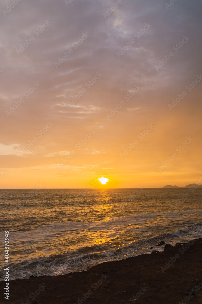 Beautiful sunset in Lima Peru, bright sky and underexposed beach, golden hour, orange sky