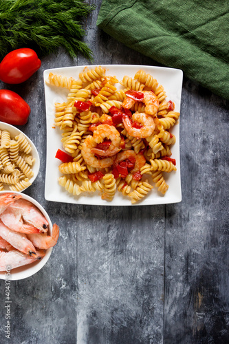 Asian food creative concept. Shrimps with Fusilli pasta and vegetables.