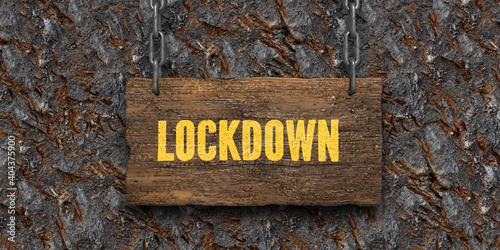 .wooden sign on chains with message LOCKDOWN in front of stone background