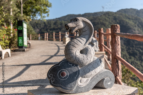 Stone statue of the Year of the Snake in GuangDong GuanYin mountain national forestpark of china.Sculpture of the Chinese Zodiac.
 photo