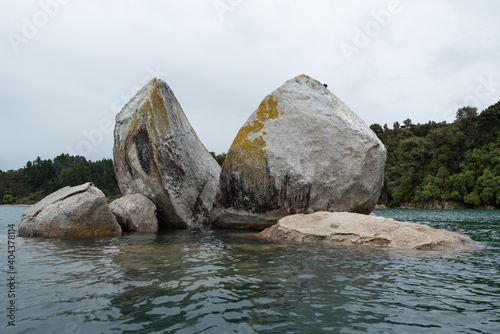 Split Apple Rock, or Tokangawha. This is a large granite boulder that has split down a natural joint in the rock. Tasman Bay, New Zealand. photo