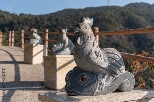 Stone statue of the Year of the Rooster in GuangDong GuanYin mountain national forestpark of china.Sculpture of the Chinese Zodiac. photo