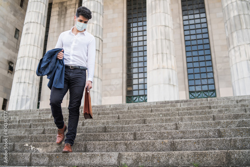 Business man holding a briefcase.