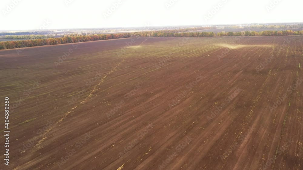 Sandstorm in the field - wind erosion of the top layer of fruitful soil - Destruction of the top layer of fruitful soil on the farm field - Aerial View Shot. Sandstorm in the field - wind erosion of the top layer of fruitful soil - Destruction of the top layer of fruitful soil on the farm field - Aerial View Shot.