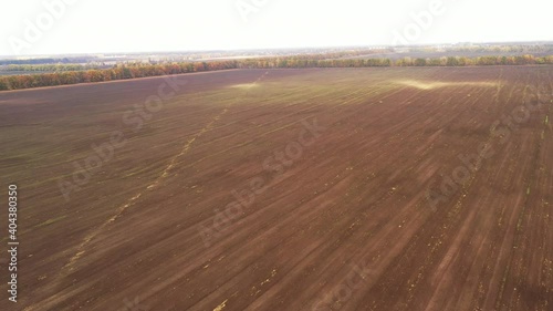 Sandstorm in the field - wind erosion of the top layer of fruitful soil - Destruction of the top layer of fruitful soil on the farm field - Aerial View Shot. photo