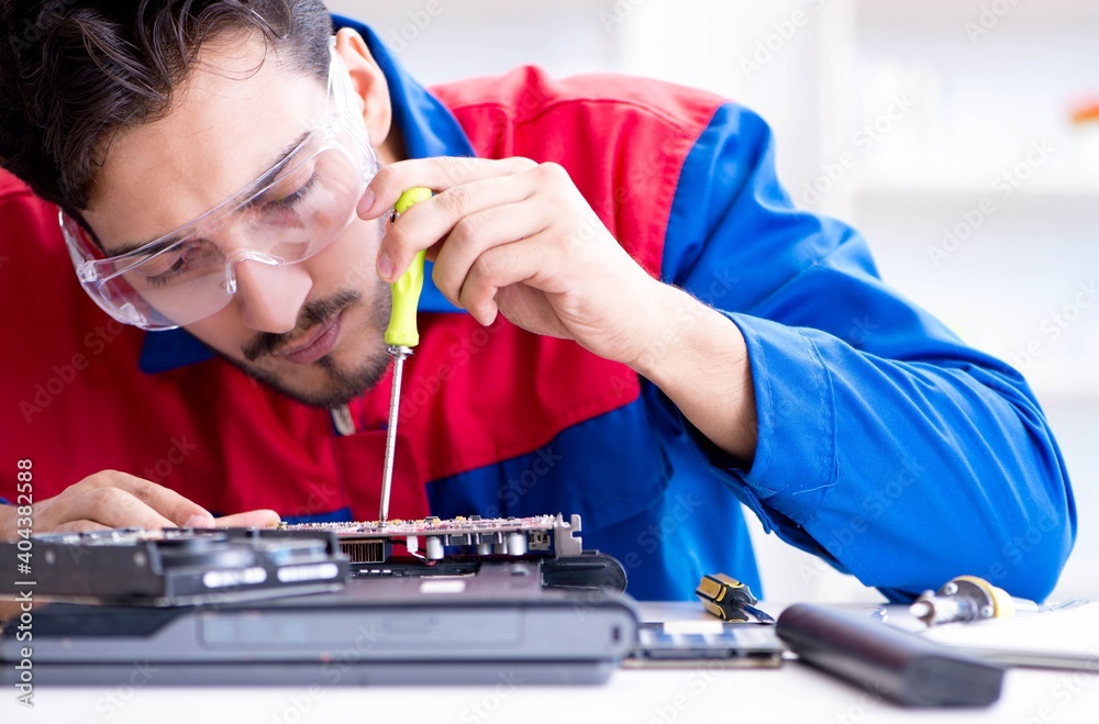 Repairman working in technical support fixing computer laptop tr