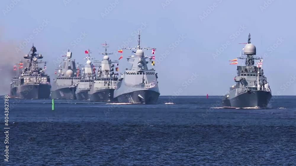 A line ahead of modern russian military naval battleships warships with submarine in the row, northern fleet and baltic sea fleet, summer sunny day, vibrant image