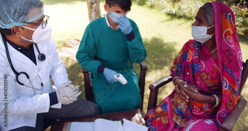 Slow-motion of medical staff doctor professional in  check examine advice educate awareness about safety and hygiene women with face mask in Hindu red saree, Muslim Hijab in outdoors rural India  
