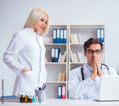 Male and female doctor having discussion in hospital