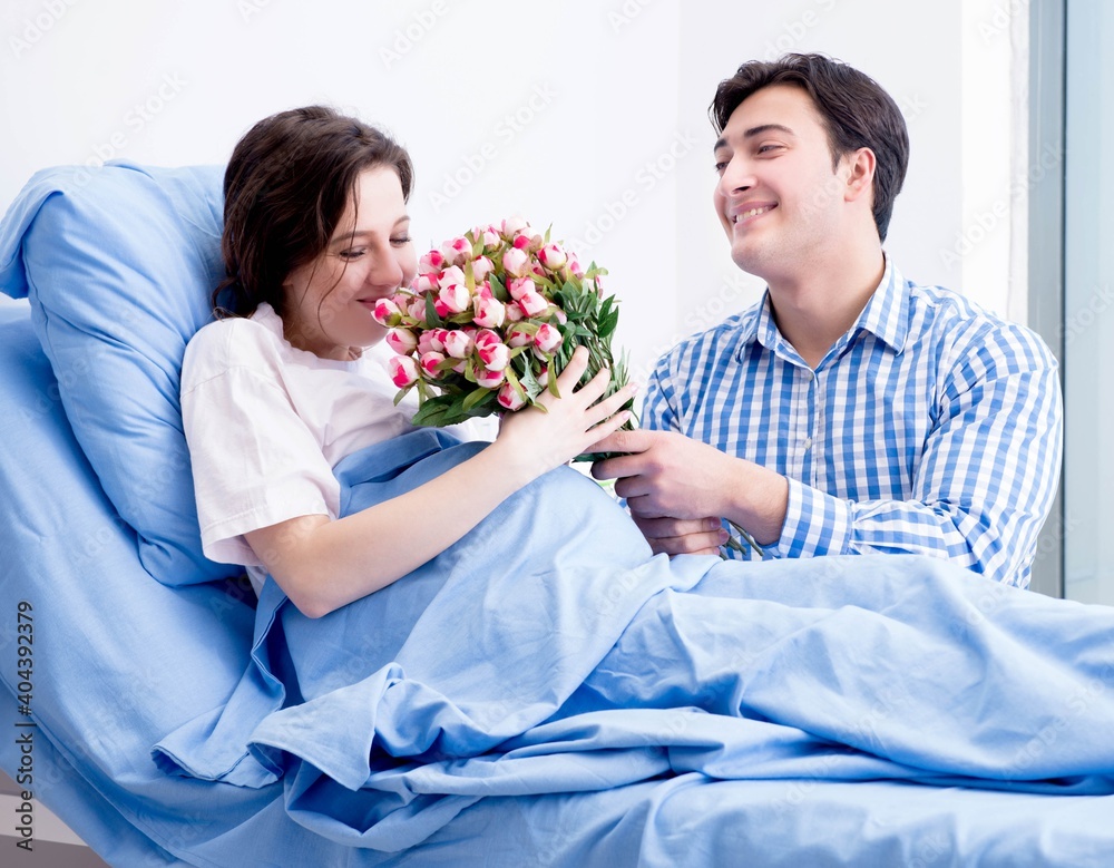 Caring loving husband visiting pregnant wife in hospital Caring loving husband visiting pregnant wife in hospital
