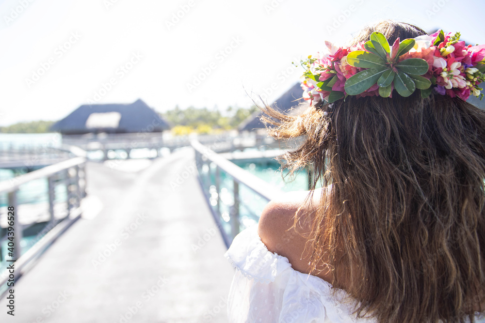 Naklejka premium Woman wearing colorful flower crown on vacation at beautiful tropical island Bora Bora in French Polynesia