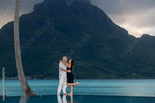 Happy couple in love on a romantic vacation at tropical island Bora Bora in French Polynesia