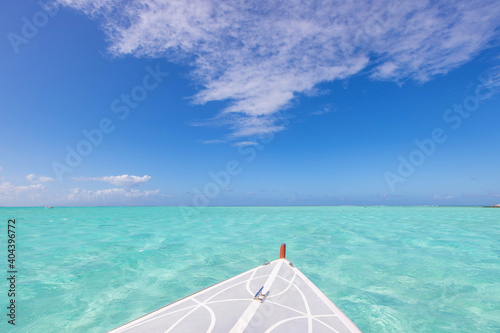 Bow of a boat over clear tropical turquoise ocean water under a vibrant blue sky on a sunny day in the South Pacific