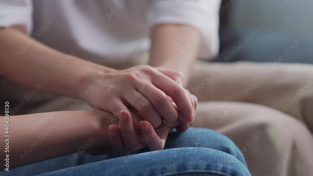 Close-up shot of two people holding hands for encouragement. Close-up shot of two people holding hands for encouragement.