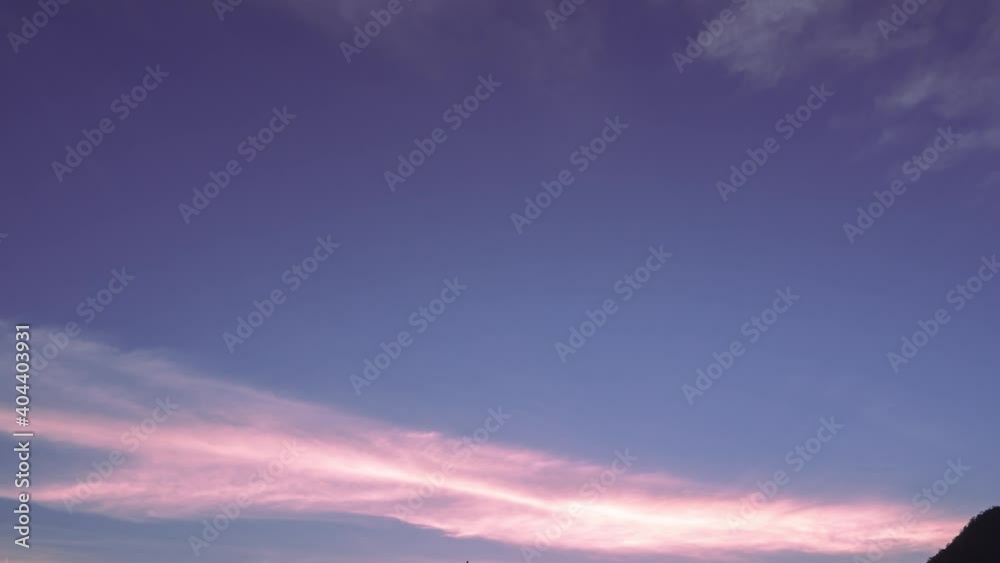 purple sky with altostratus clouds line across the sky from left to right in horizontal. pink clouds and space at the middle of the screen. sunset sunrise skyline colorful sunlight, nature background. purple sky with altostratus clouds line across the sky from left to right in horizontal. pink clouds and space at the middle of the screen. sunset sunrise skyline colorful sunlight, nature background.