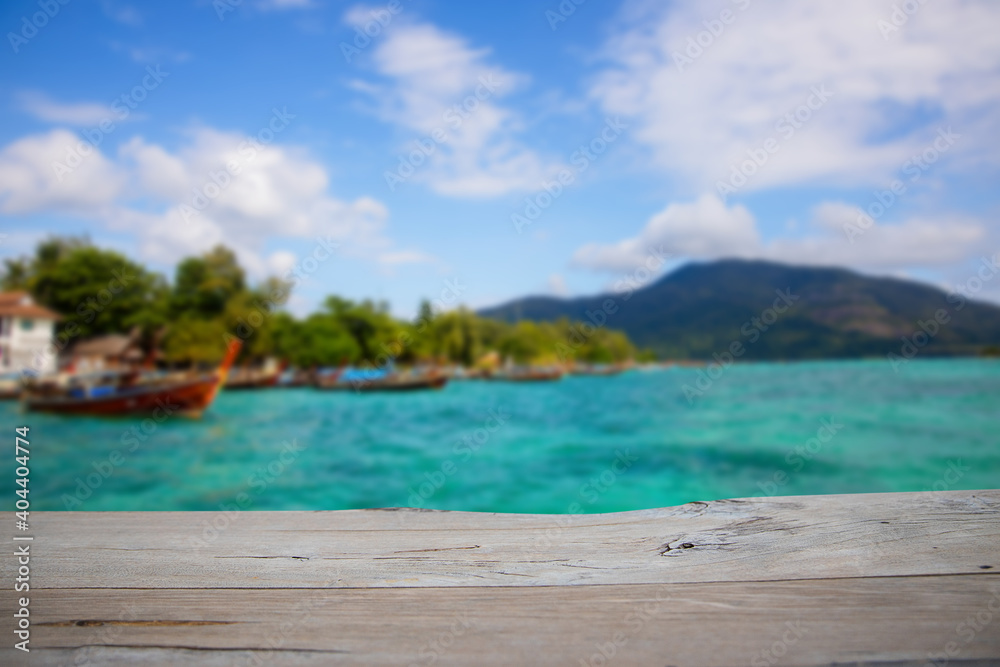Fototapeta premium empty wood table for present product with soft blur natural sea with mountain background